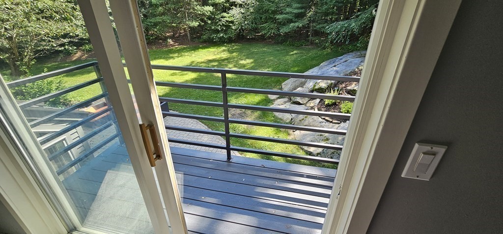 62 Chestnut Street Upton, MA 01568 - Photo 30 of 36 a view of a balcony with floor to ceiling windows with wooden floor