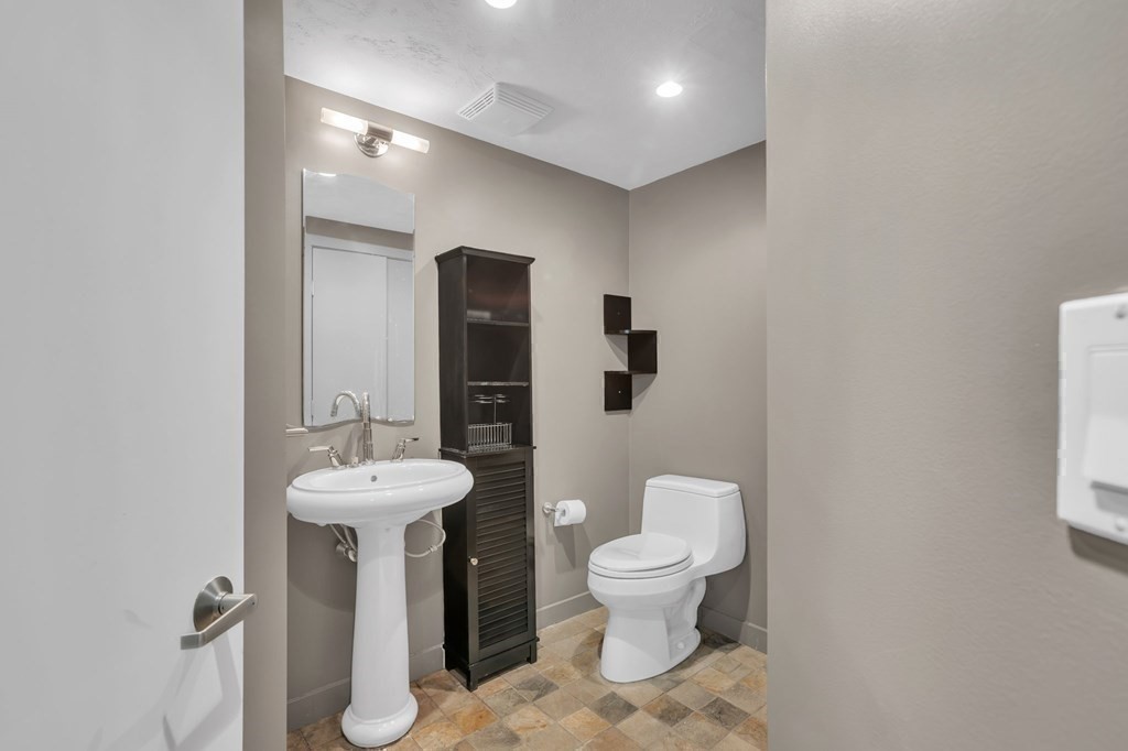 62 Chestnut Street Upton, MA 01568 - Photo 35 of 36 a bathroom with a toilet sink and mirror