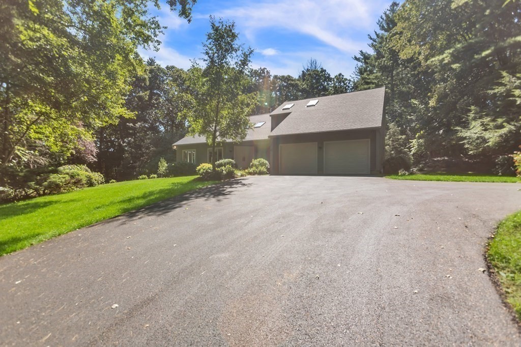 62 Chestnut Street Upton, MA 01568 - Photo 4 of 36 a backyard of a house with plants and large trees