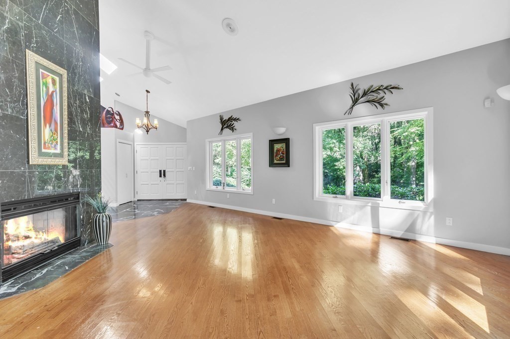 62 Chestnut Street Upton, MA 01568 - Photo 10 of 36 a view of an empty room with a fireplace and a window