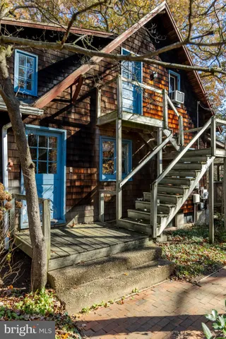 a view of a hallway with wooden floor and a fireplace