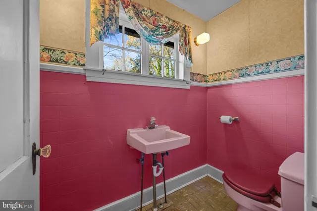 a bathroom with a granite countertop sink and a large mirror