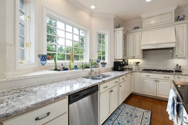 a living room with furniture a bookshelf and a window