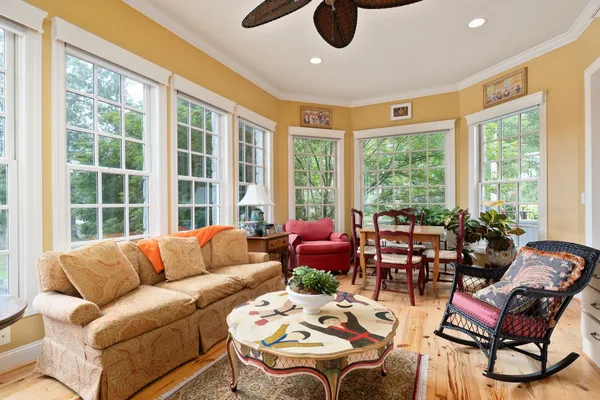 a bedroom with a bed and a large window with balcony view