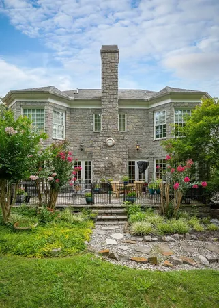 a backyard of a house with table and chairs
