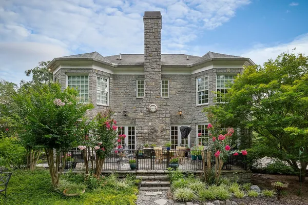 a view of a chairs and table in backyard