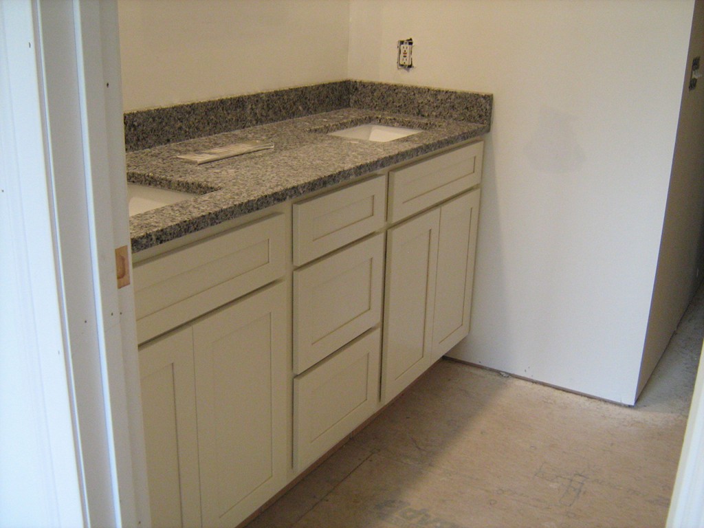 302 Piper Road, Unit 2A West Springfield, MA 01089 - Photo 6 of 6 a bathroom with a granite countertop sink and washing machine