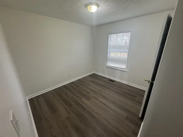 a view of a backyard with wooden fence