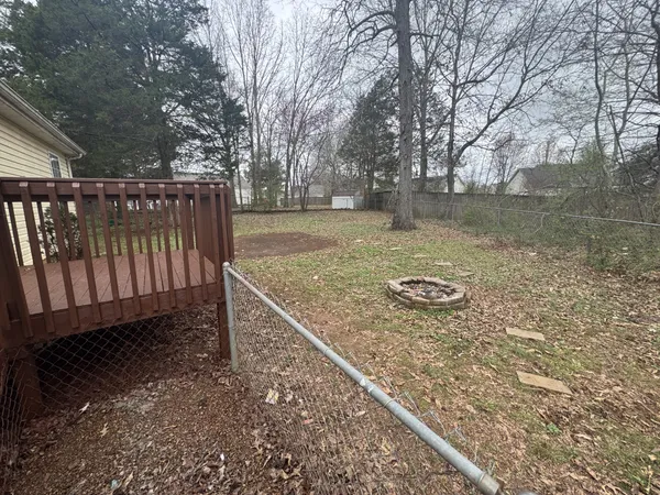 a view of a house with a yard and deck