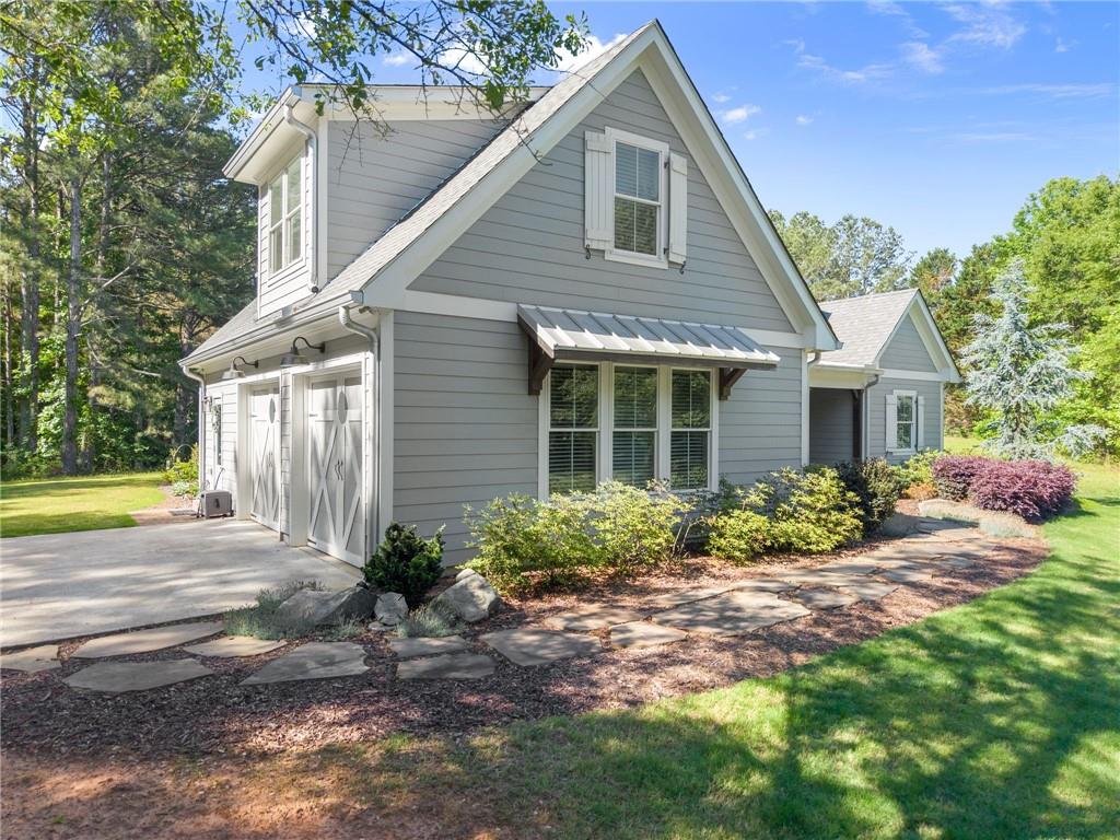 5822 John Burruss Road Cumming, GA 30040 - Photo 50 of 65 a front view of a house with garden