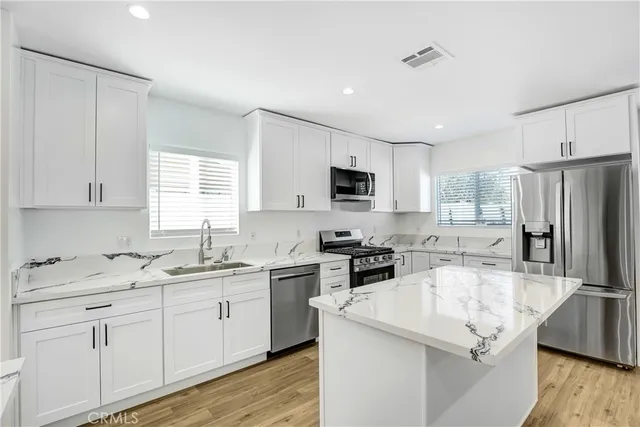 a kitchen with a sink stove and microwave
