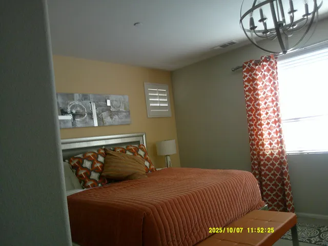 a bedroom with a bed and window