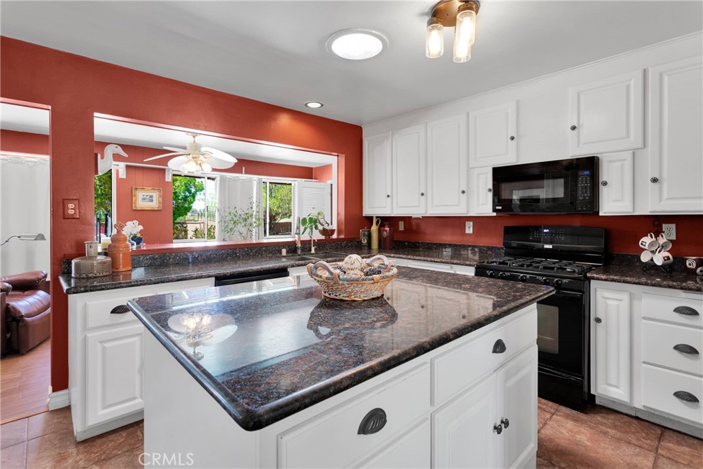19955 Chickasaw Road Apple Valley, CA 92307 - Photo 19 of 60 a kitchen with stainless steel appliances granite countertop a sink stove and cabinets