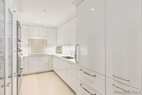 a kitchen with white cabinets and white appliances
