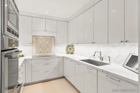 a kitchen with cabinets appliances a sink and a window