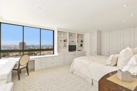 a large bedroom with a large bed and a large window