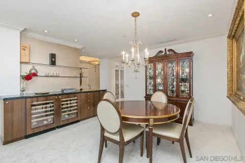 a kitchen with stainless steel appliances kitchen island granite countertop a table chairs in it and wooden floors