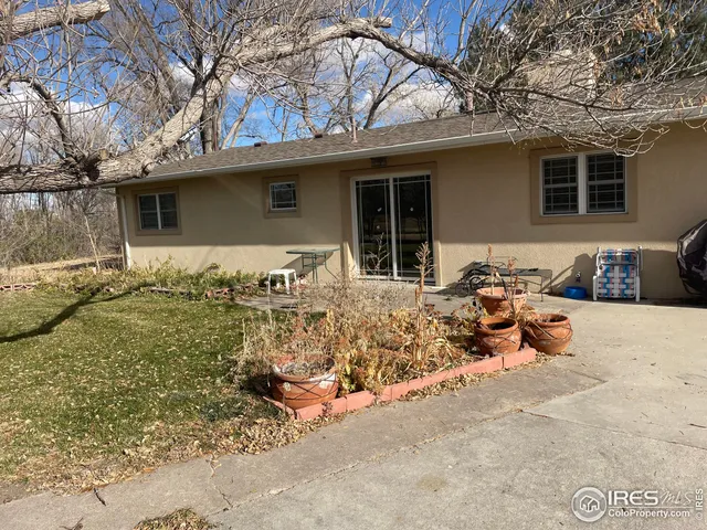 a view of a backyard with table and chairs and a fire pit