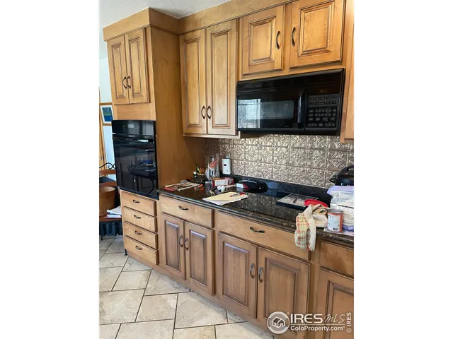 a kitchen with stainless steel appliances granite countertop a stove and a microwave