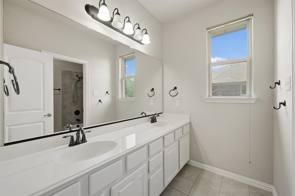 12809 Spring Hill Drive Frisco, TX 75035 - Photo 32 of 37 a bathroom with a sink and a mirror