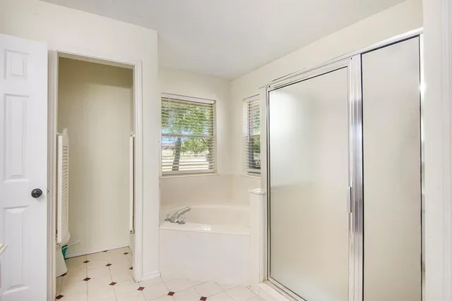 a bathroom with a bathtub and a shower