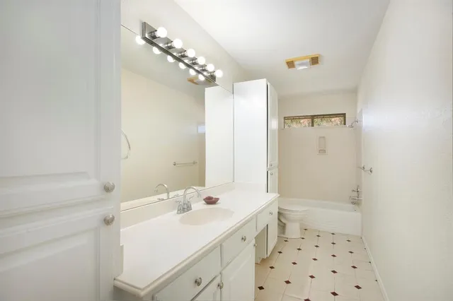 a bathroom with a sink a large mirror and a shower