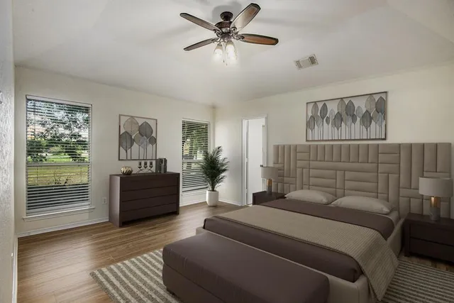a bedroom with a large bed and a chandelier