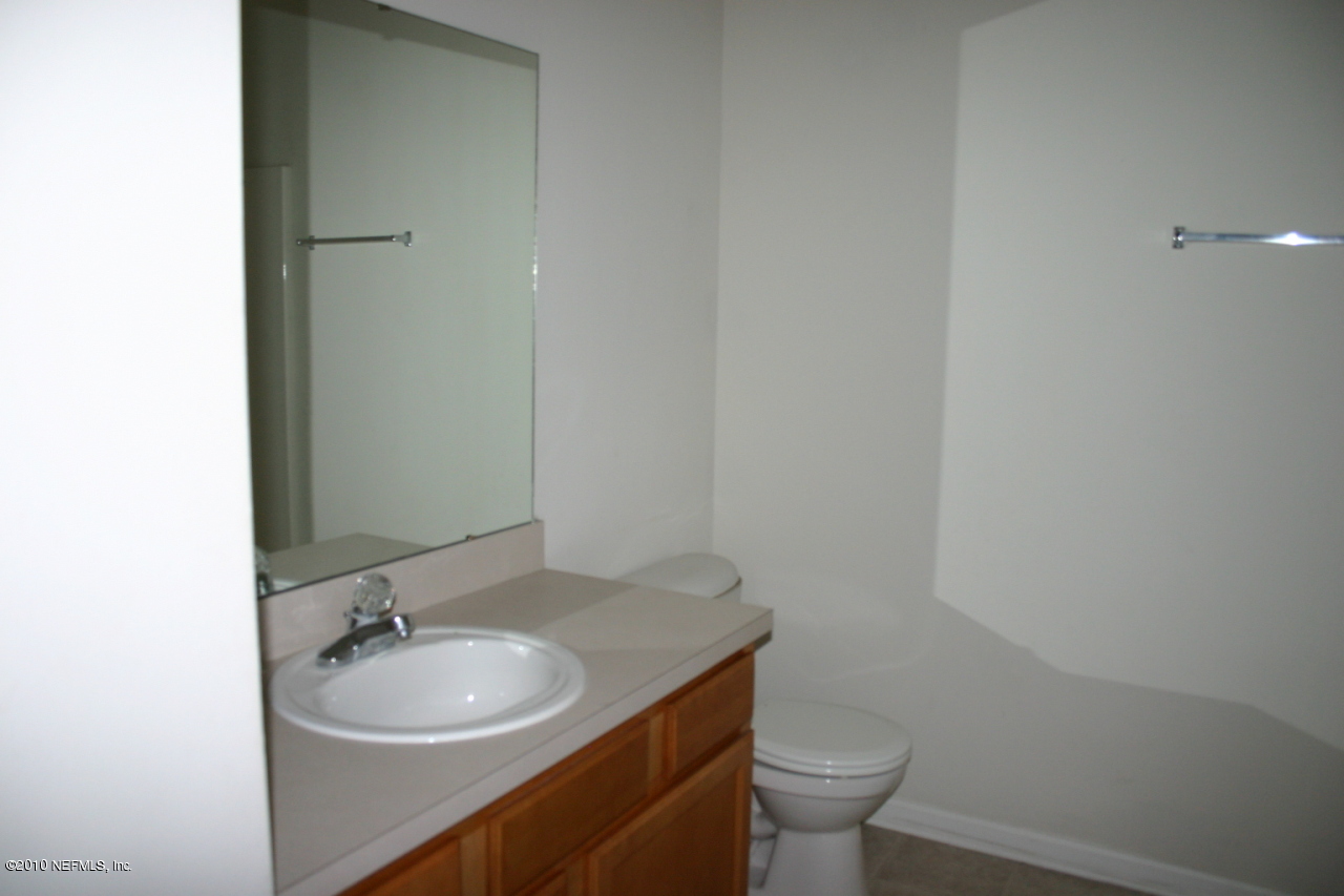7920 Merrill Road, Unit 1002 Jacksonville, FL 32277 - Photo 12 of 18 a bathroom with a sink and a toilet