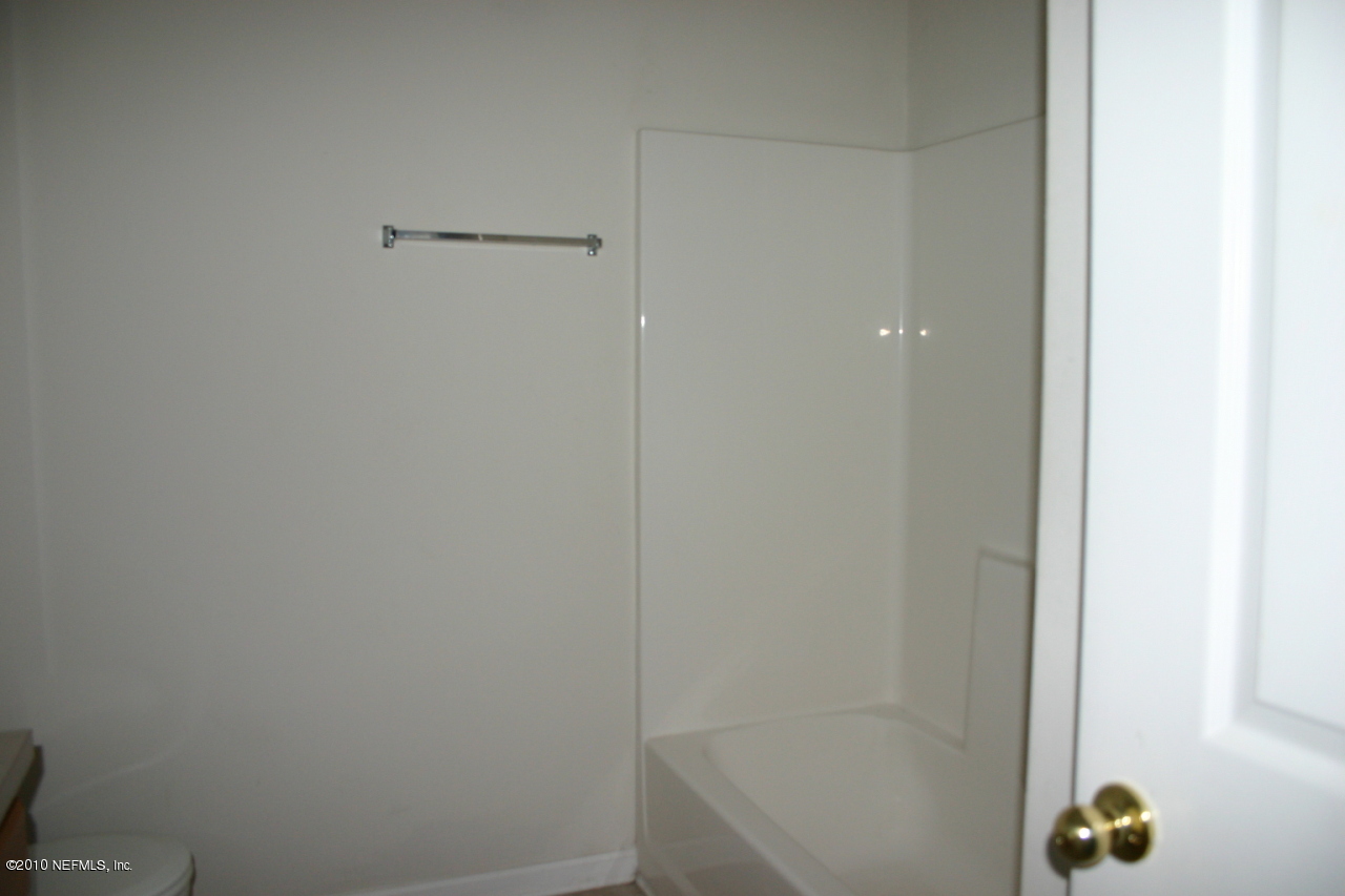 7920 Merrill Road, Unit 1002 Jacksonville, FL 32277 - Photo 13 of 18 a bathroom with a bathtub