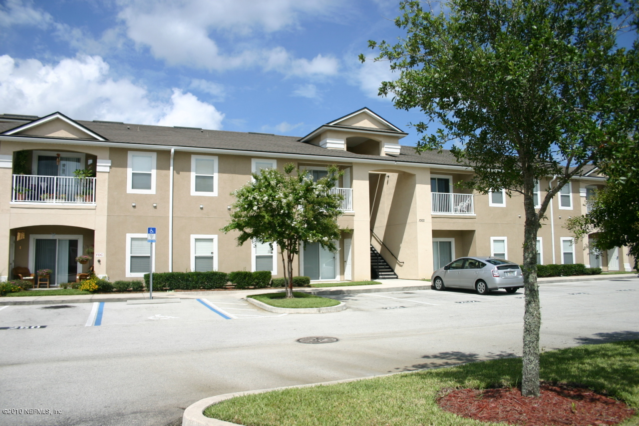 7920 Merrill Road, Unit 1002 Jacksonville, FL 32277 - Photo 3 of 18 a front view of a house with a yard