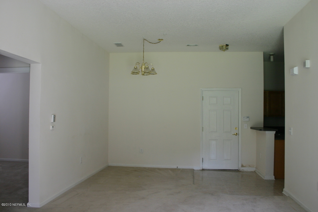 7920 Merrill Road, Unit 1002 Jacksonville, FL 32277 - Photo 7 of 18 an empty room with a door