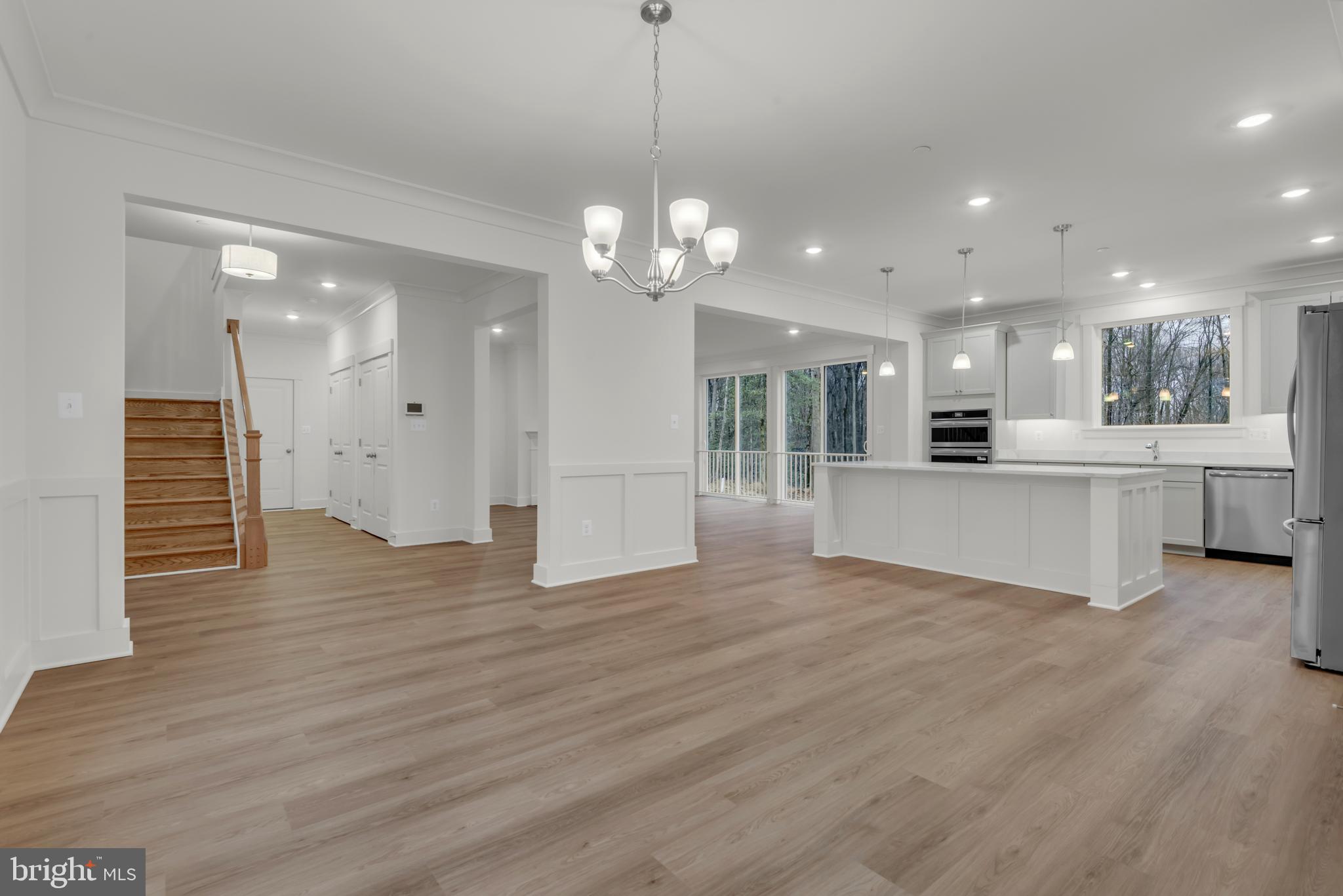 6502 Whitetail Xing Way Hanover, MD 21076 - Photo 15 of 58 a view of a kitchen and an empty room with wooden floor