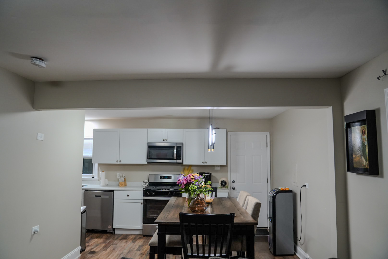 15315 Cherry Lane Markham, IL 60428 - Photo 7 of 34 a kitchen with stainless steel appliances a dining table chairs microwave and sink