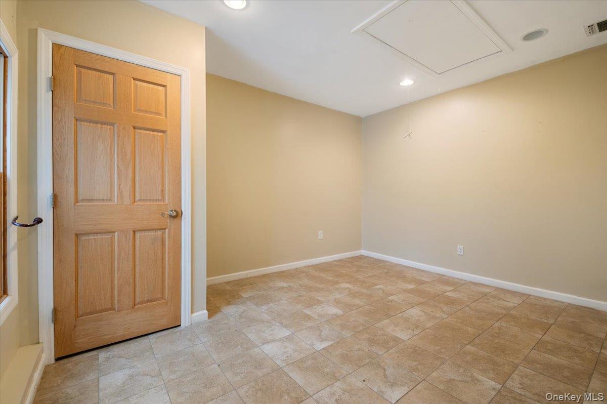 33 Fleets Cove Road Huntington, NY 11743 - Photo 34 of 42 Spare room with recessed lighting and attic access