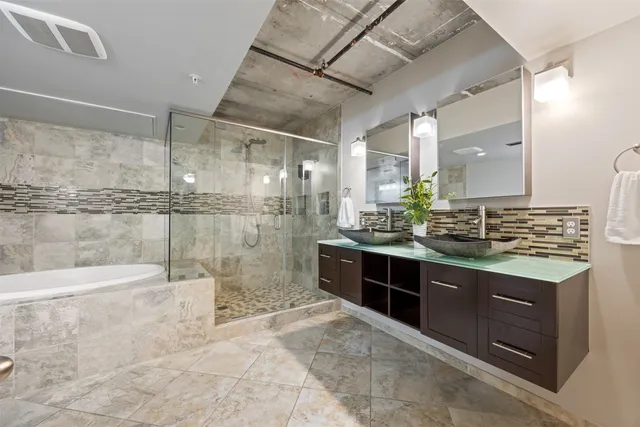 a bathroom with a granite countertop sink mirror and shower