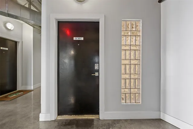 an empty room with windows and closet