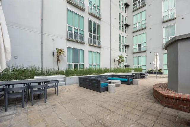 a view of a patio with dining table and chairs