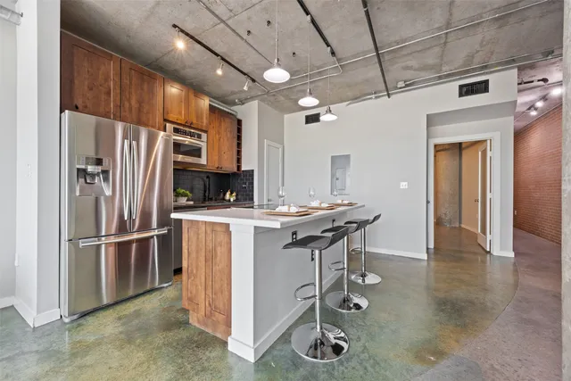 a kitchen with refrigerator and cabinets