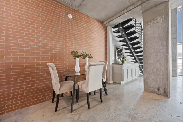 a view of a dining room with furniture and entryway