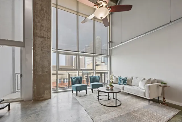 a living room with furniture and a ceiling fan