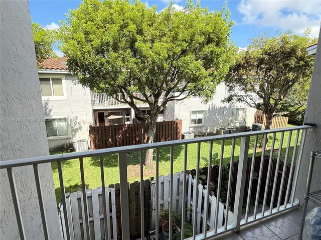 a view of a swimming pool with a garden and plants