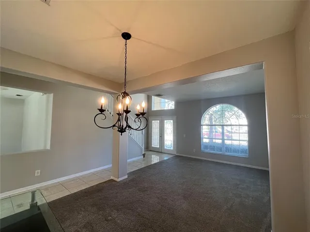 an empty room with a empty space and windows