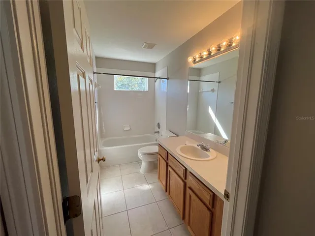 a view of a livingroom with a ceiling fan and window