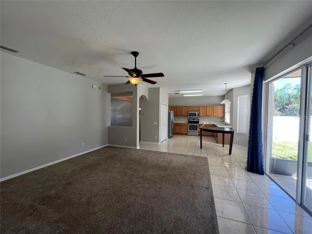 a view of empty room with wooden floor and fireplace