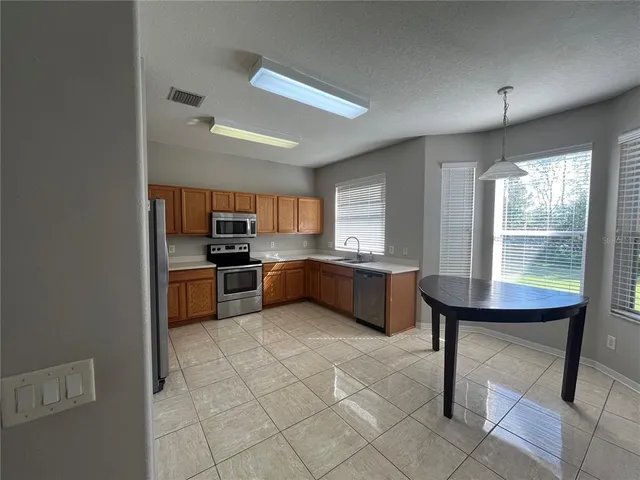 a kitchen with a sink a counter top space and appliances