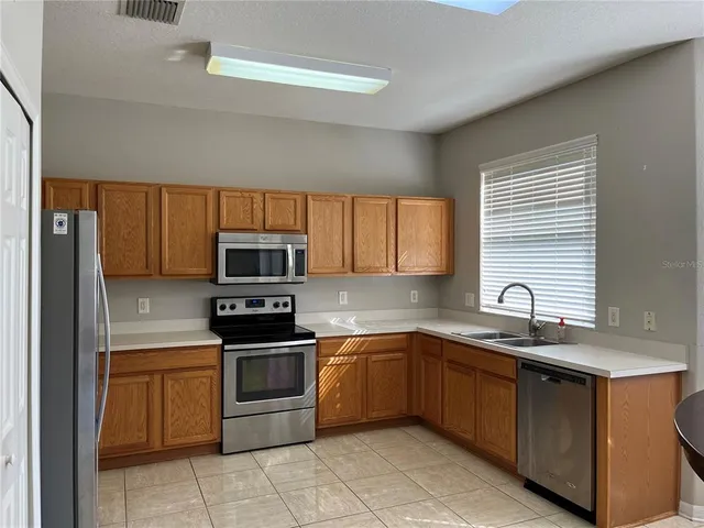 a kitchen with a sink stove and microwave