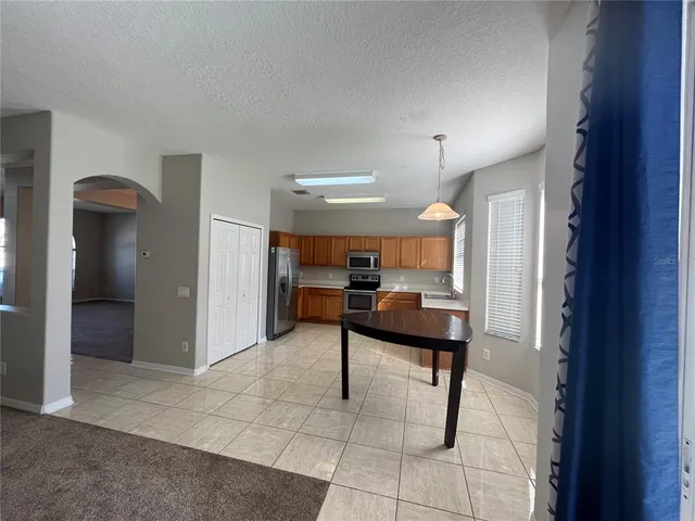 a view of a livingroom with furniture and a window