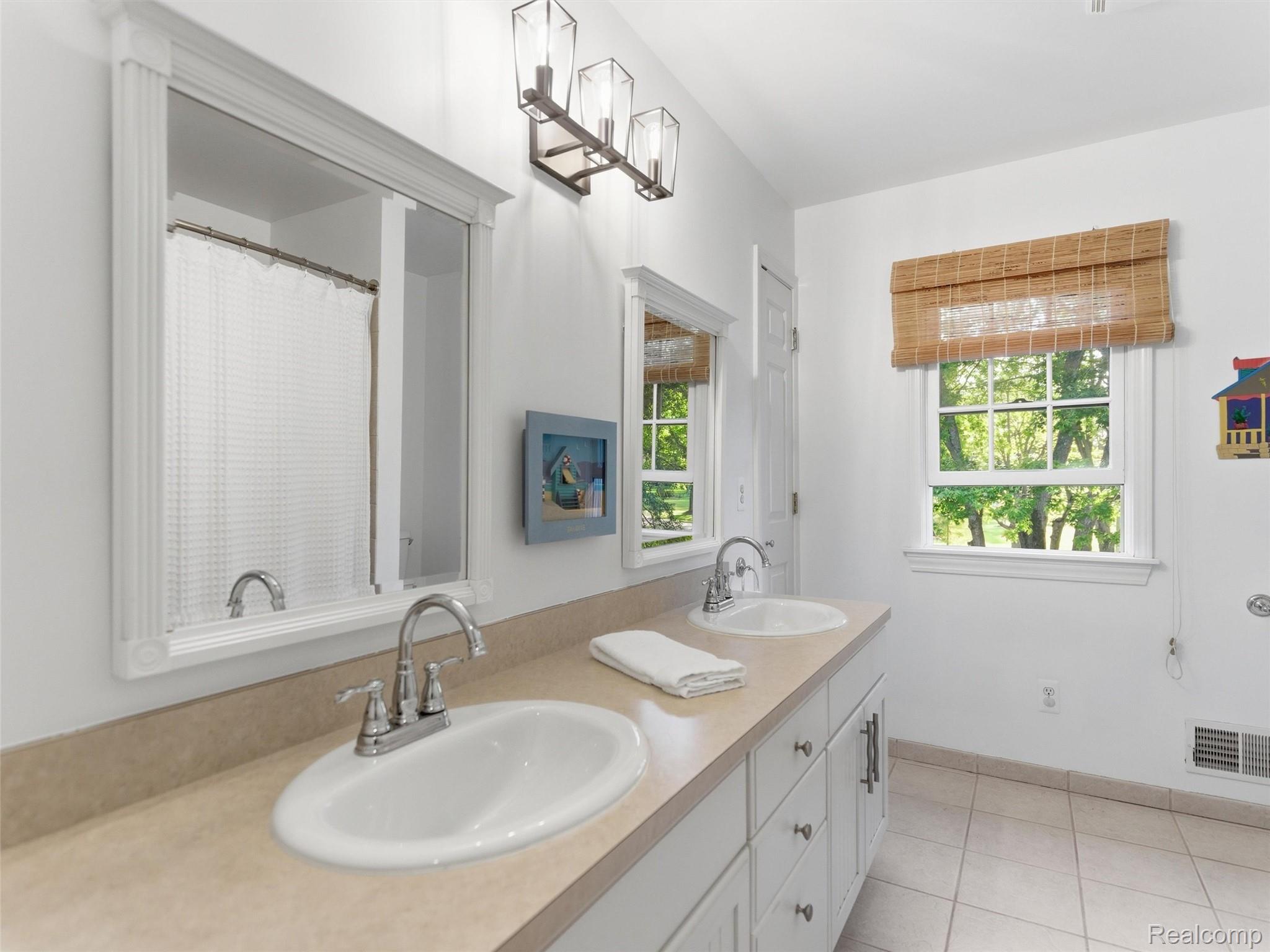 1185 Avon Circle West Rochester, MI 48309 - Photo 42 of 74 Full bath with dual sinks, ceramic tile and white cabinetry