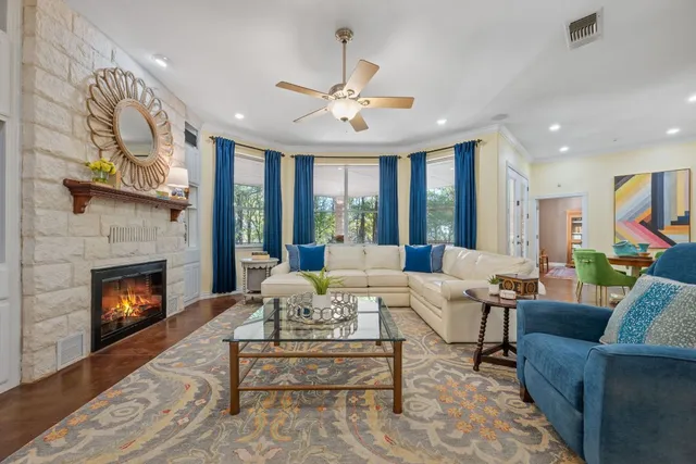 a living room with furniture fireplace and a large window