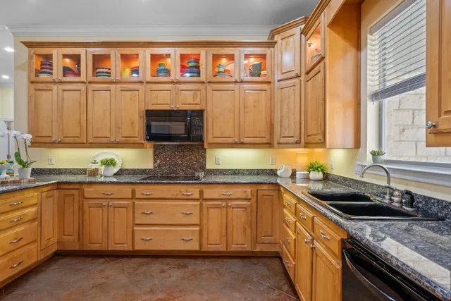 a kitchen with stainless steel appliances granite countertop a sink and a stove
